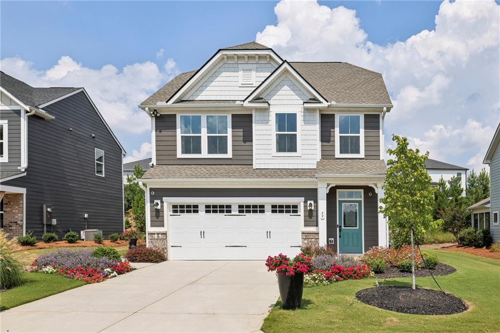39 Clubview Drive Hoschton, GA 30548 - Photo 1 of 1 a front view of a house with a yard and garage