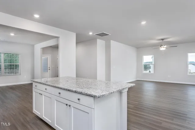 wooden floor white cabinets and entryway