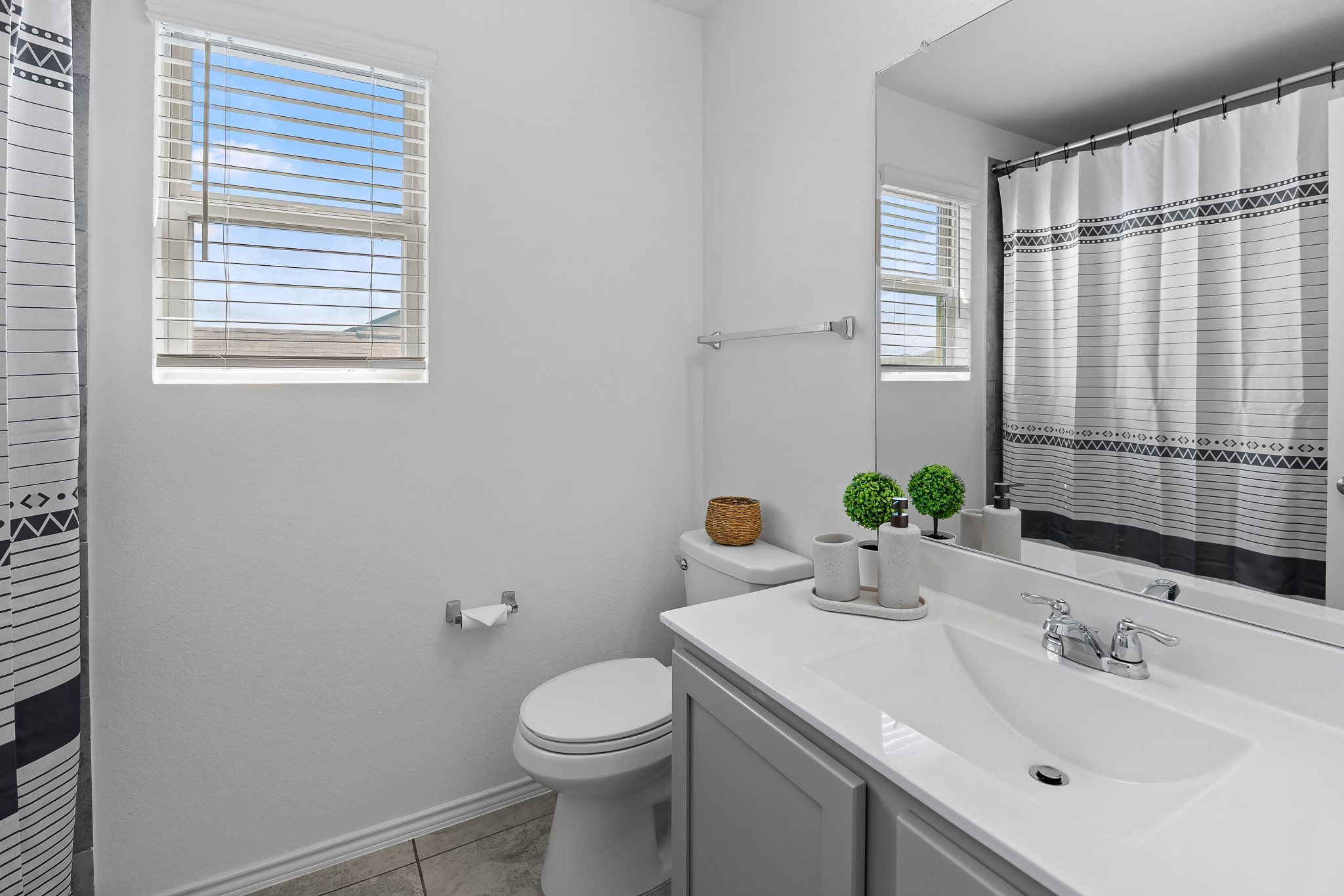 576 Greatest Gift Way Jarrell, TX 76537 - Photo 23 of 37 Brightly illuminated with natural light, this full bath features modern fixtures and a vanity with ample counter space.