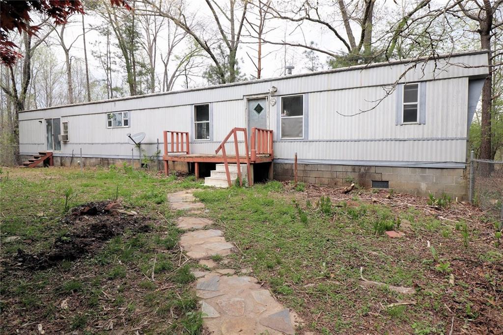 5750 Liberty Road Winston, GA 30187 - Photo 1 of 1 a view of a white house with a big yard and large trees