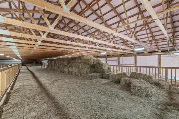 a work room with furniture a chandelier fan and a window