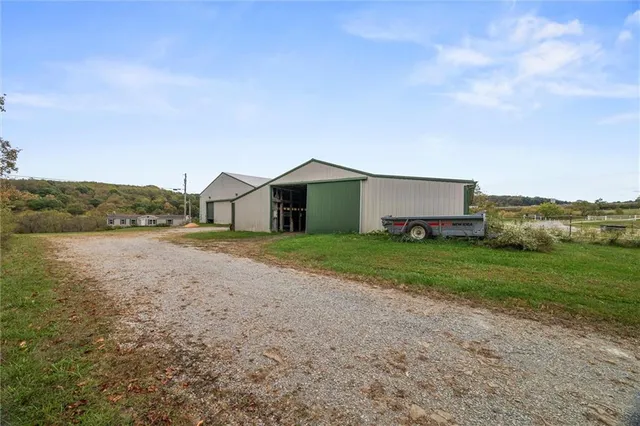a view of a city with lawn chairs and large trees