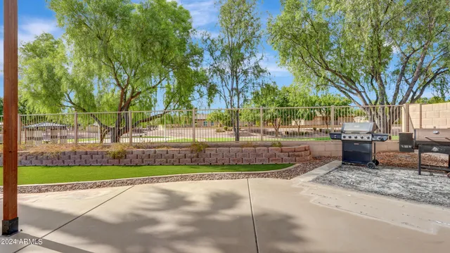 a view of house with a big yard potted plants and seating space