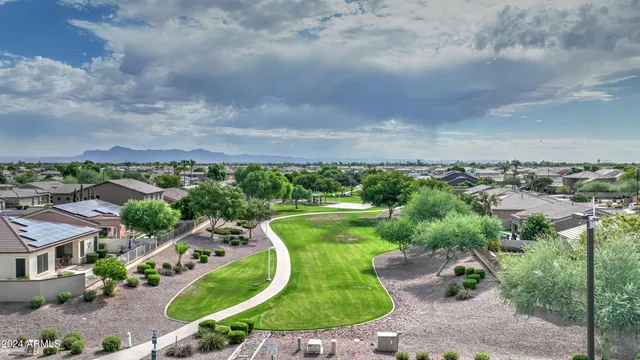 a swimming pool with outdoor seating and garden