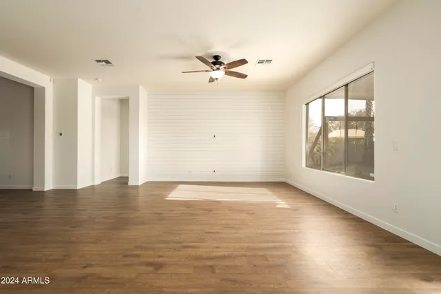 wooden floor in an empty room with a window