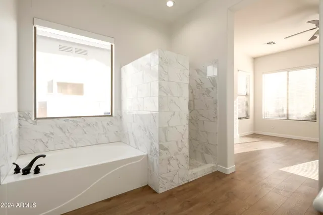 a bathroom with a sink a mirror and a shower