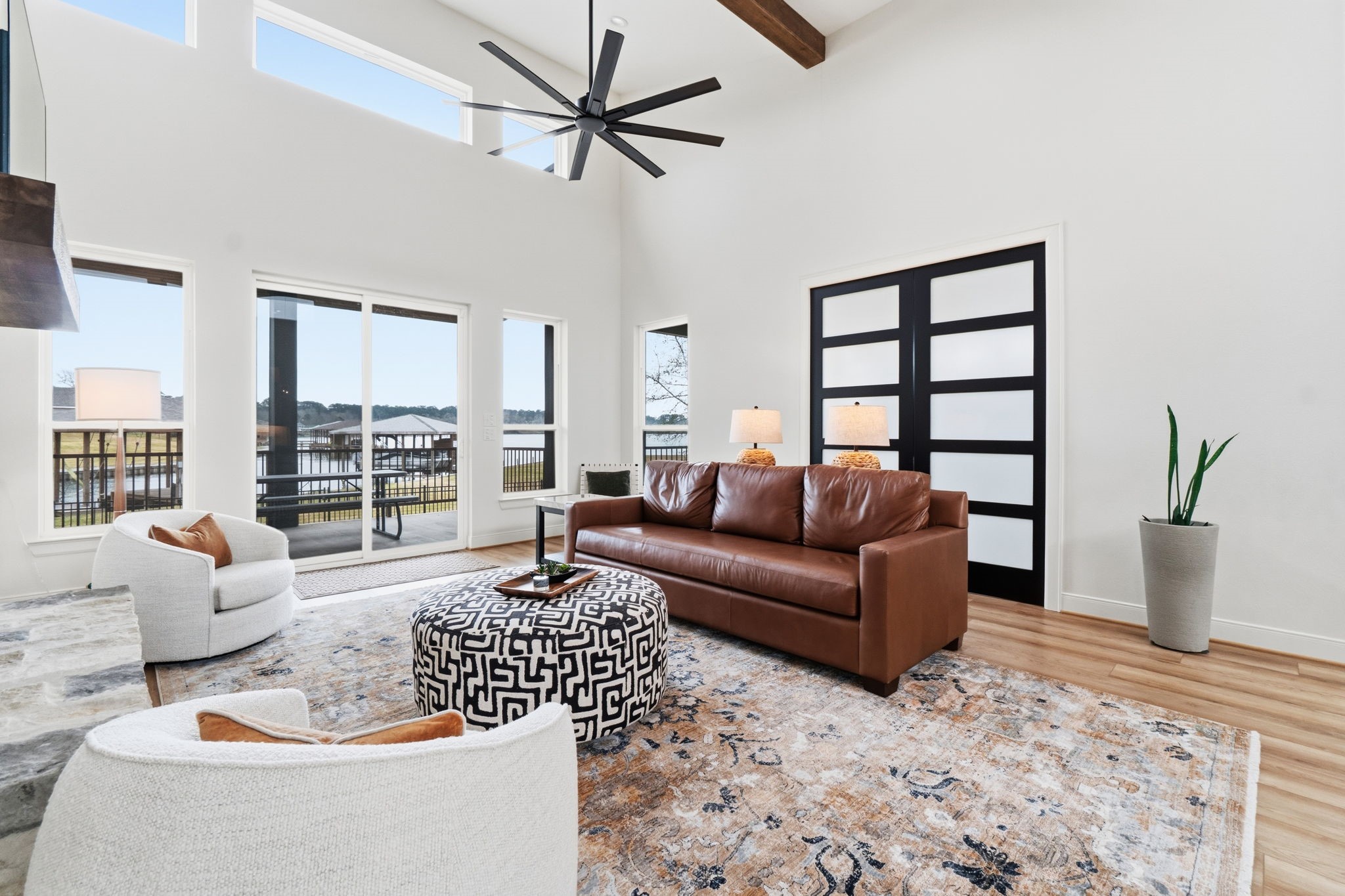 255 Peninsula Drive Livingston, TX 77351 - Photo 23 of 50 Tall windows with a sliding glass door and transoms flood the space with natural light while adding privacy. Beautiful view of the lake.