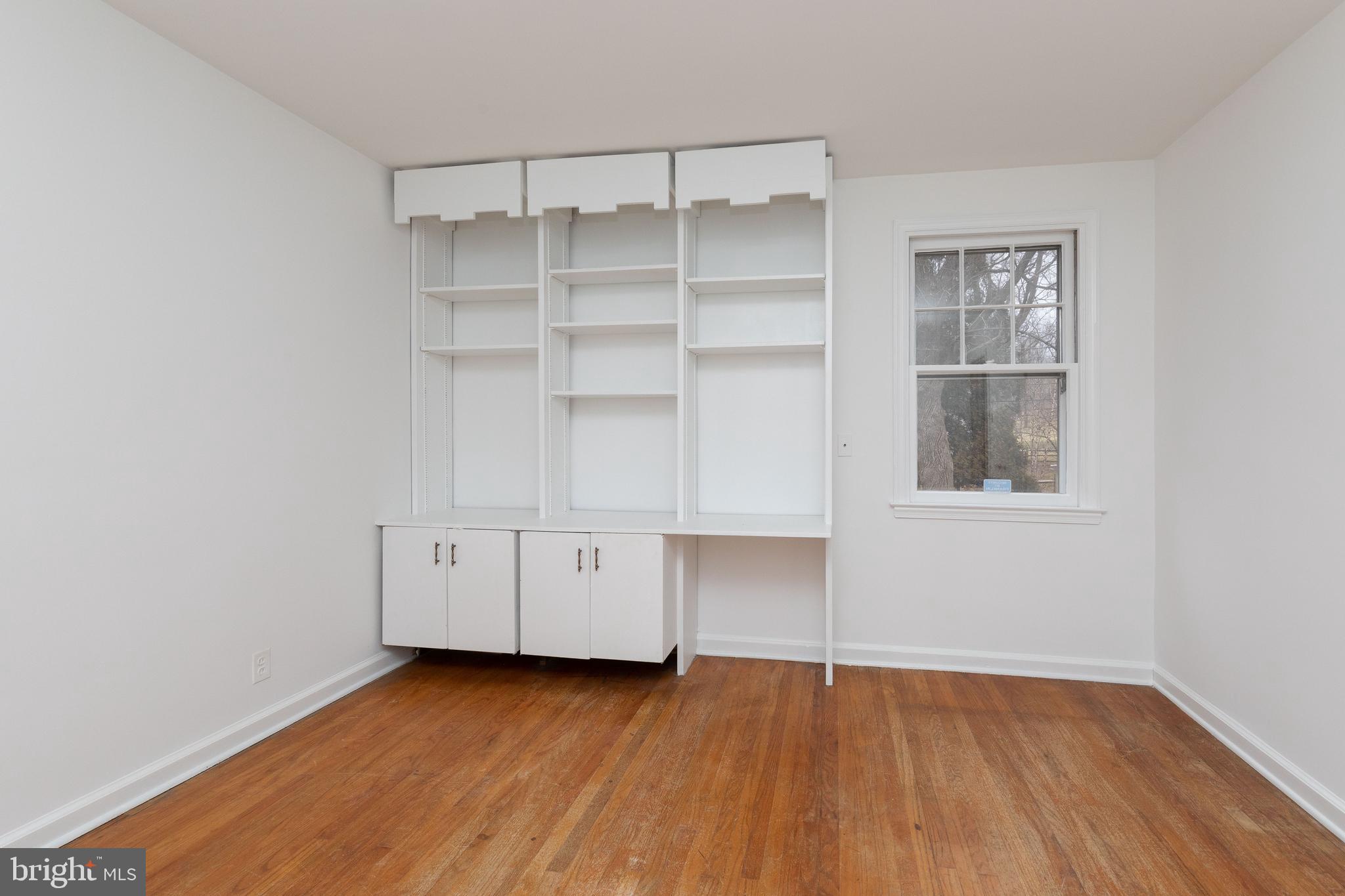 615 Arlingham Road Flourtown, PA 19031 - Photo 13 of 25 a view of an empty room with a window and wooden floor