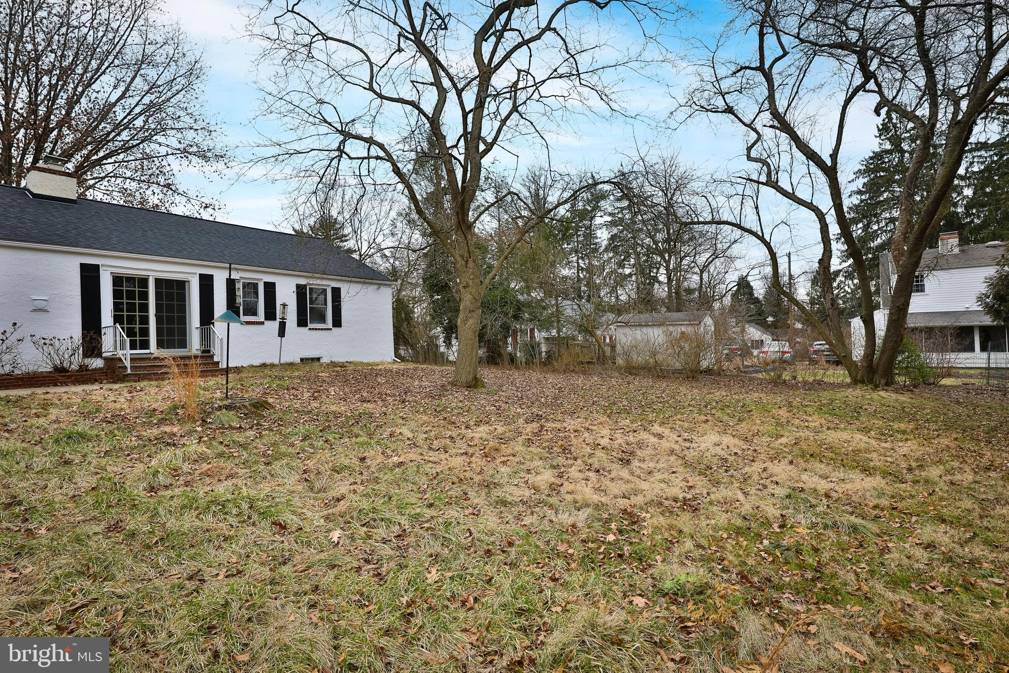 615 Arlingham Road Flourtown, PA 19031 - Photo 24 of 25 a backyard of a house with large trees and outdoor seating