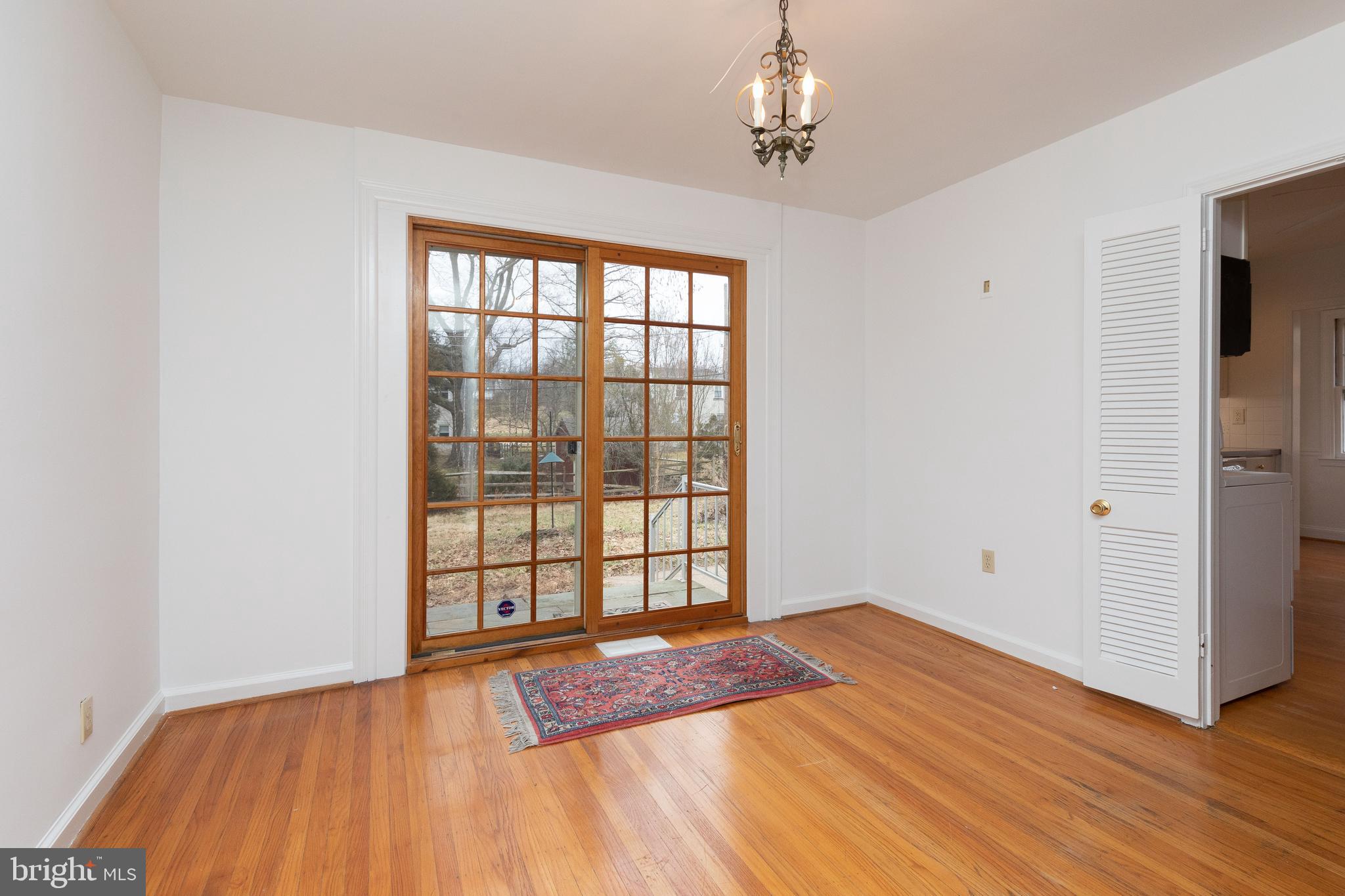 615 Arlingham Road Flourtown, PA 19031 - Photo 6 of 25 a view of an empty room with wooden floor and a window