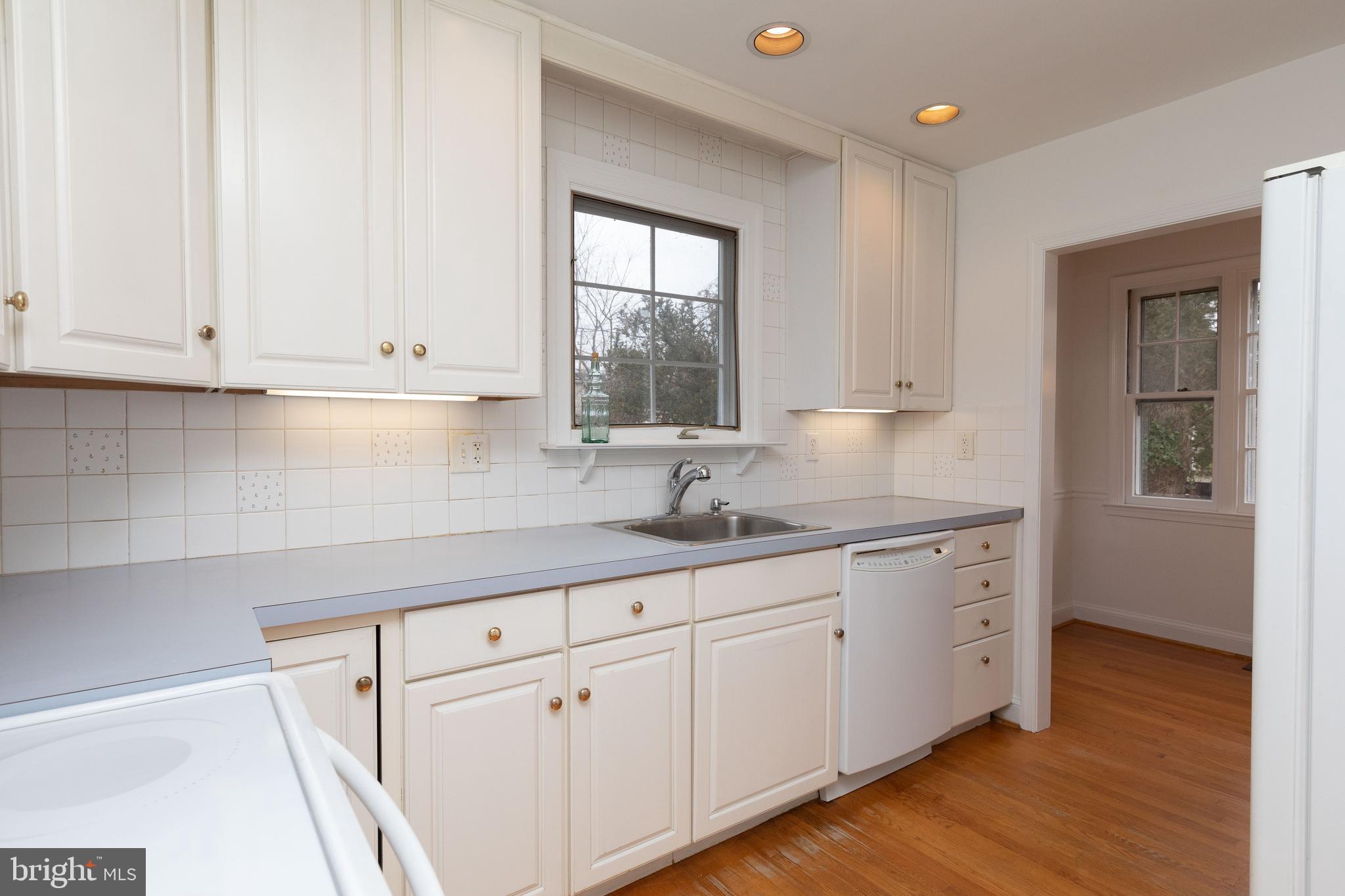 615 Arlingham Road Flourtown, PA 19031 - Photo 7 of 25 a kitchen with granite countertop white cabinets and a window