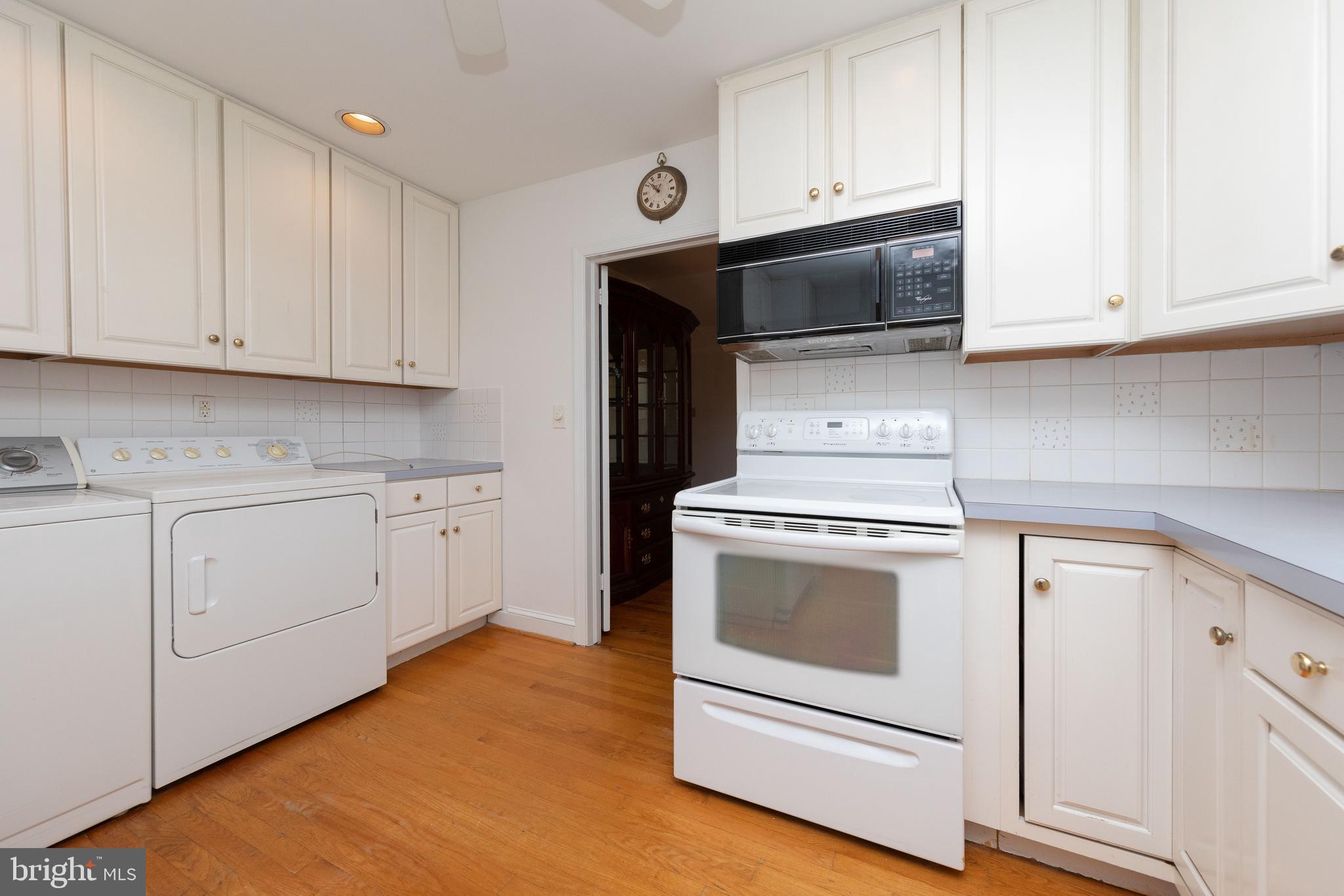 615 Arlingham Road Flourtown, PA 19031 - Photo 8 of 25 a kitchen with granite countertop white cabinets and white appliances