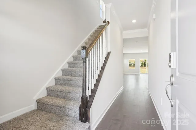 a view of entryway and hall with wooden floor
