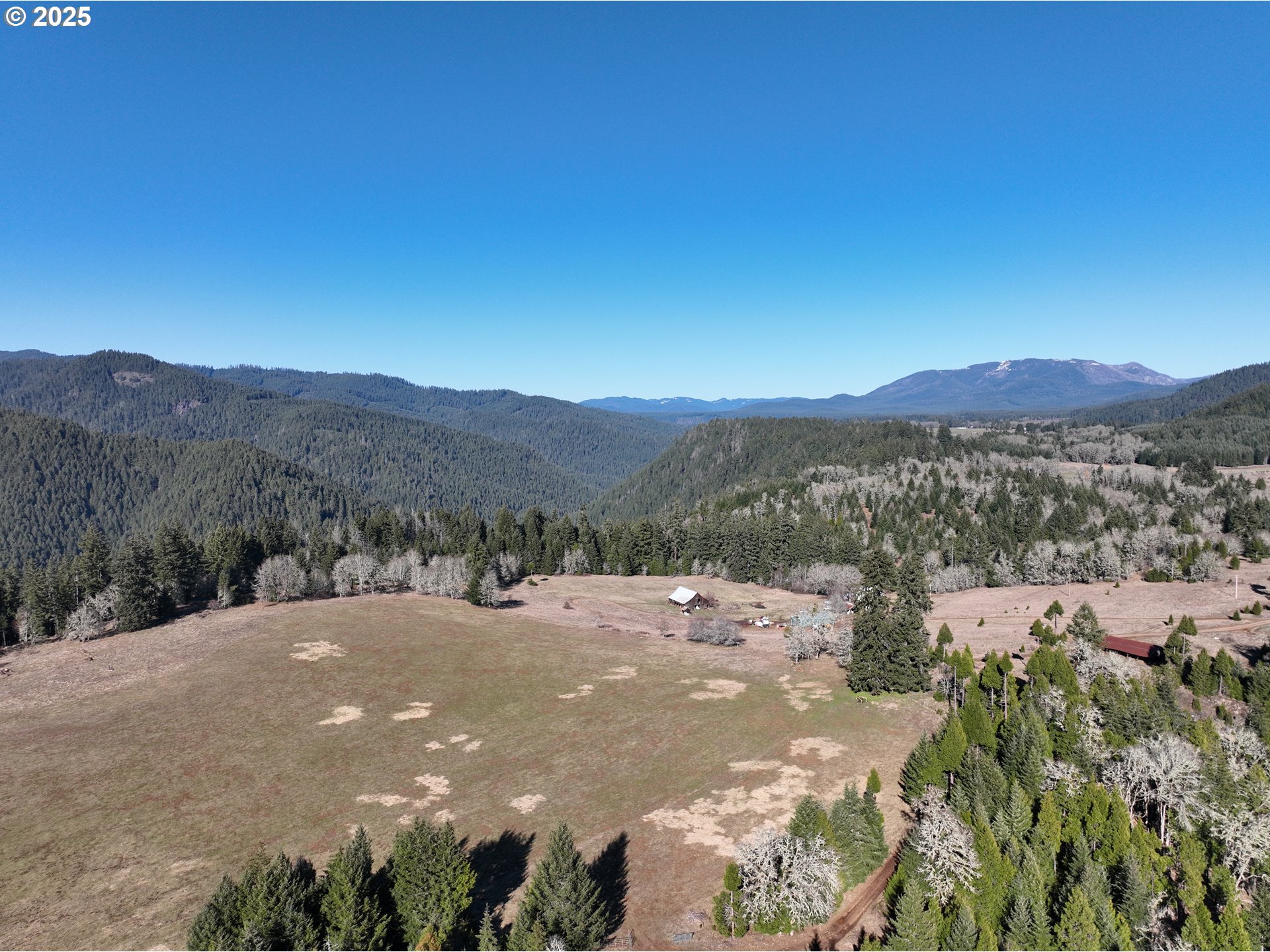 77220 Bar B L Ranch Road Oakridge, OR 97463 - Photo 2 of 24 a view of a road with mountains in the background