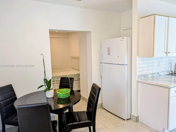 a bedroom with a couch and a stove top oven
