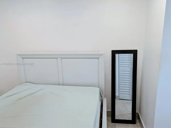 a bedroom with a bed and a cabinets