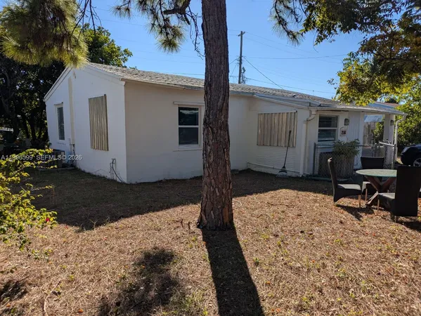 a view of a house with a tree