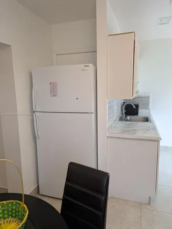 a bedroom with a couch and a stove top oven