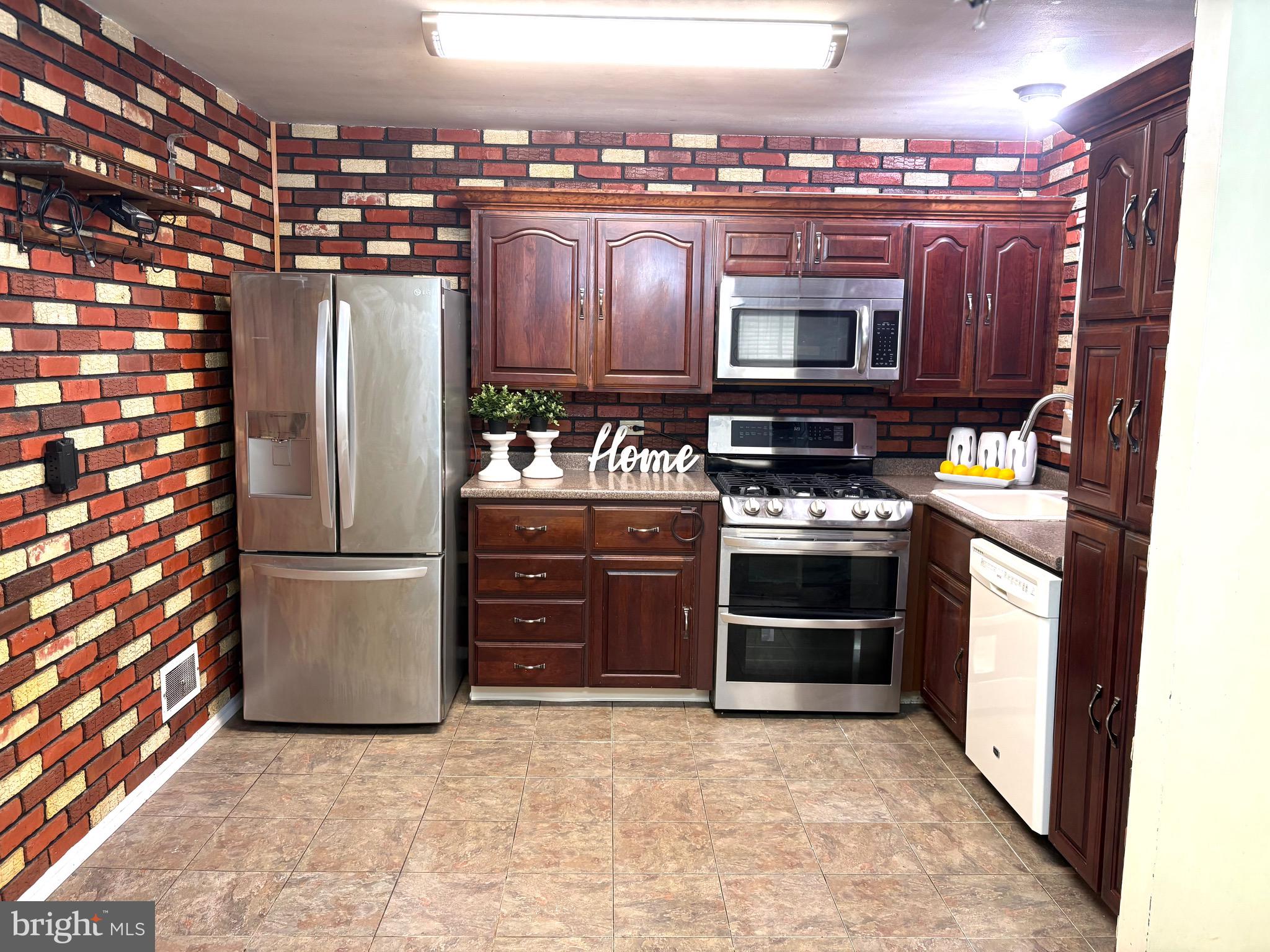 146 Ewingville Road Ewing, NJ 08638 - Photo 2 of 7 a kitchen with refrigerator and cabinets