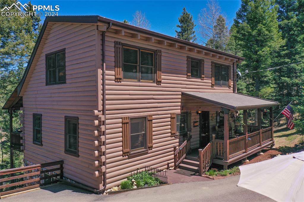 a view of a house with a yard and garage