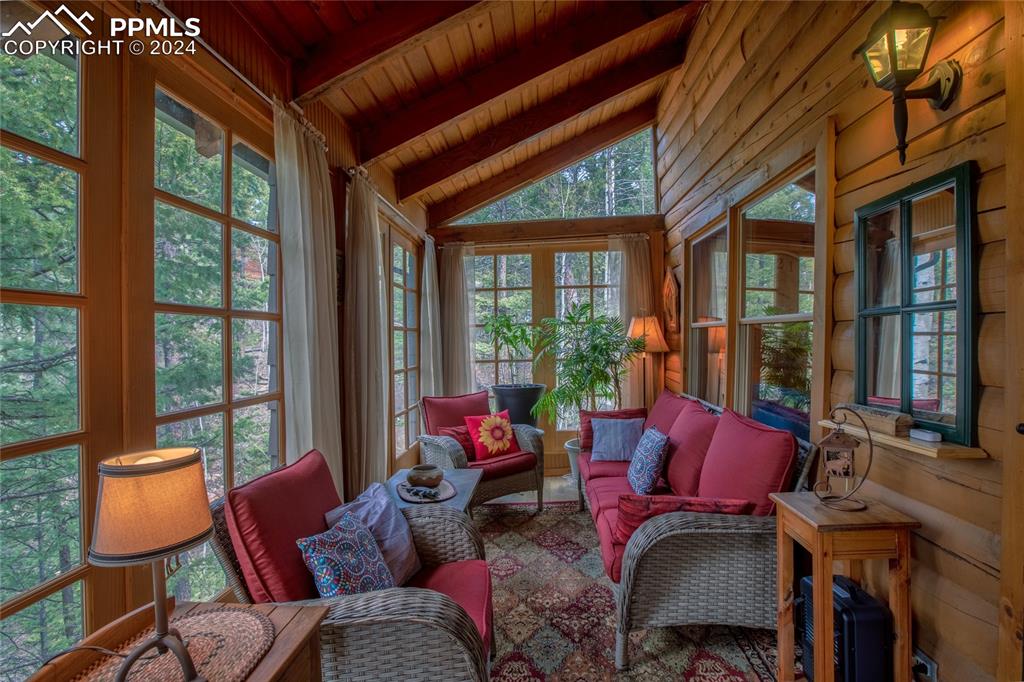 143 Wahsatch Road Florissant, CO 80816 - Photo 22 of 50 a living room with furniture a floor to ceiling window and floor to ceiling windows