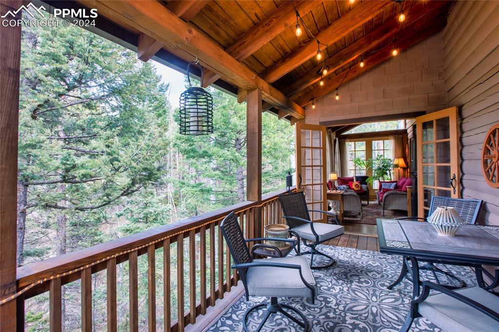 143 Wahsatch Road Florissant, CO 80816 - Photo 24 of 50 a view of a chairs and table in wooden deck
