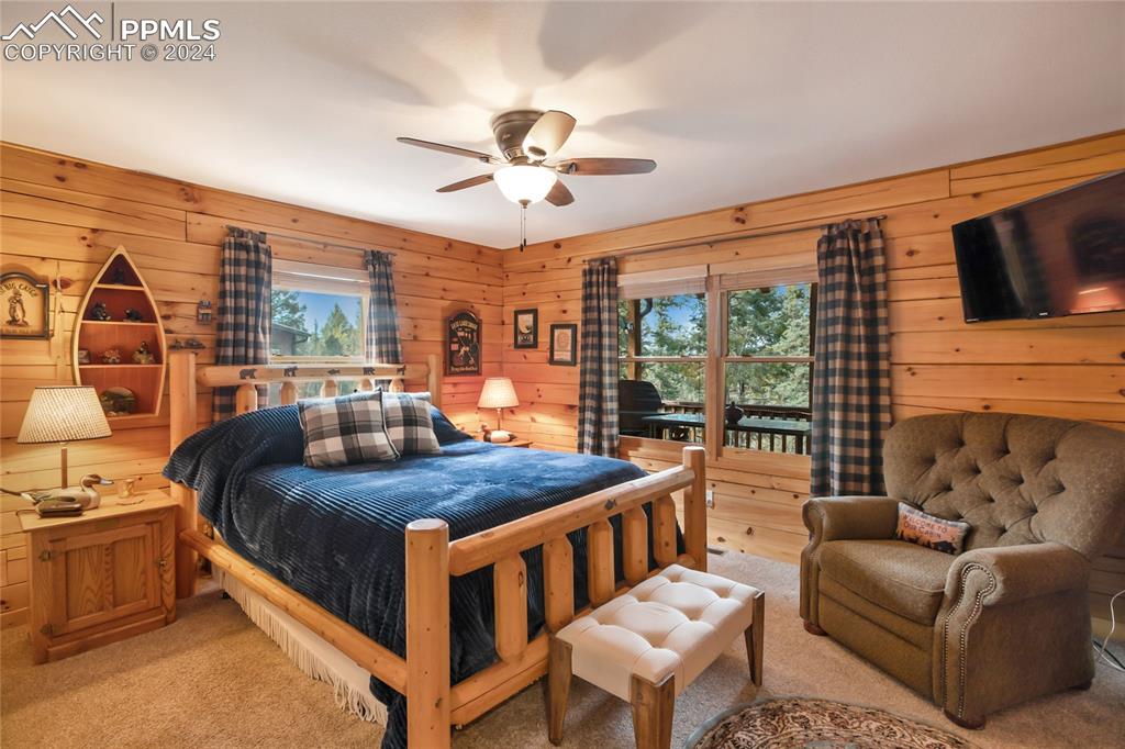 143 Wahsatch Road Florissant, CO 80816 - Photo 25 of 50 a bedroom with a bed a couch and a chandelier