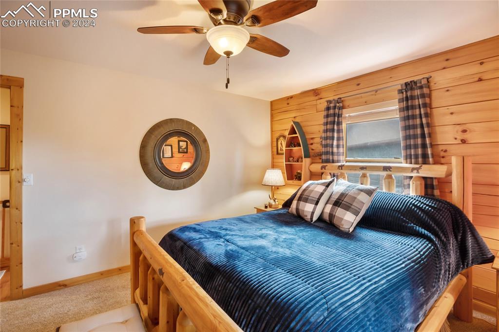 143 Wahsatch Road Florissant, CO 80816 - Photo 27 of 50 a bedroom with a bed and a lamp on dresser