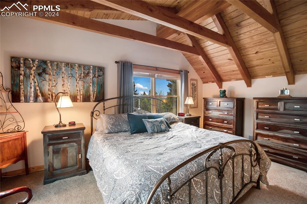 143 Wahsatch Road Florissant, CO 80816 - Photo 33 of 50 a large bedroom with a bed and wooden floor