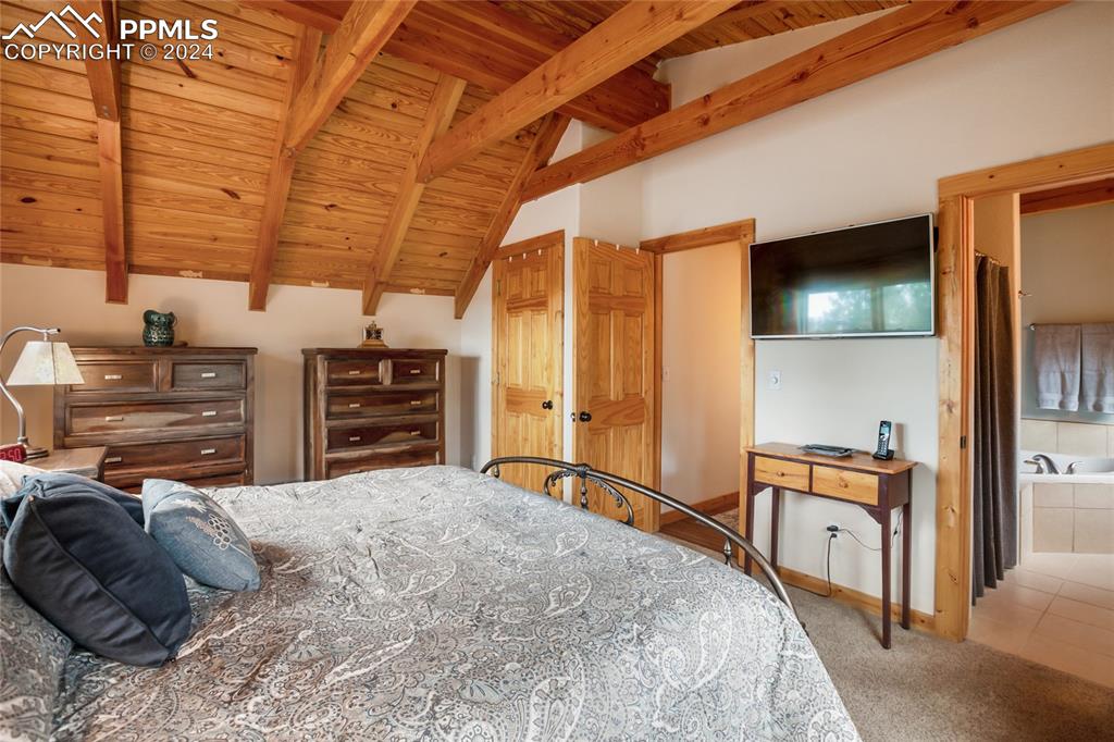 143 Wahsatch Road Florissant, CO 80816 - Photo 35 of 50 a bedroom with a bed and a television