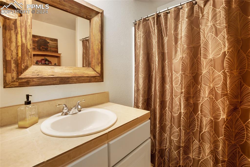 143 Wahsatch Road Florissant, CO 80816 - Photo 43 of 50 a bathroom with a sink and a mirror