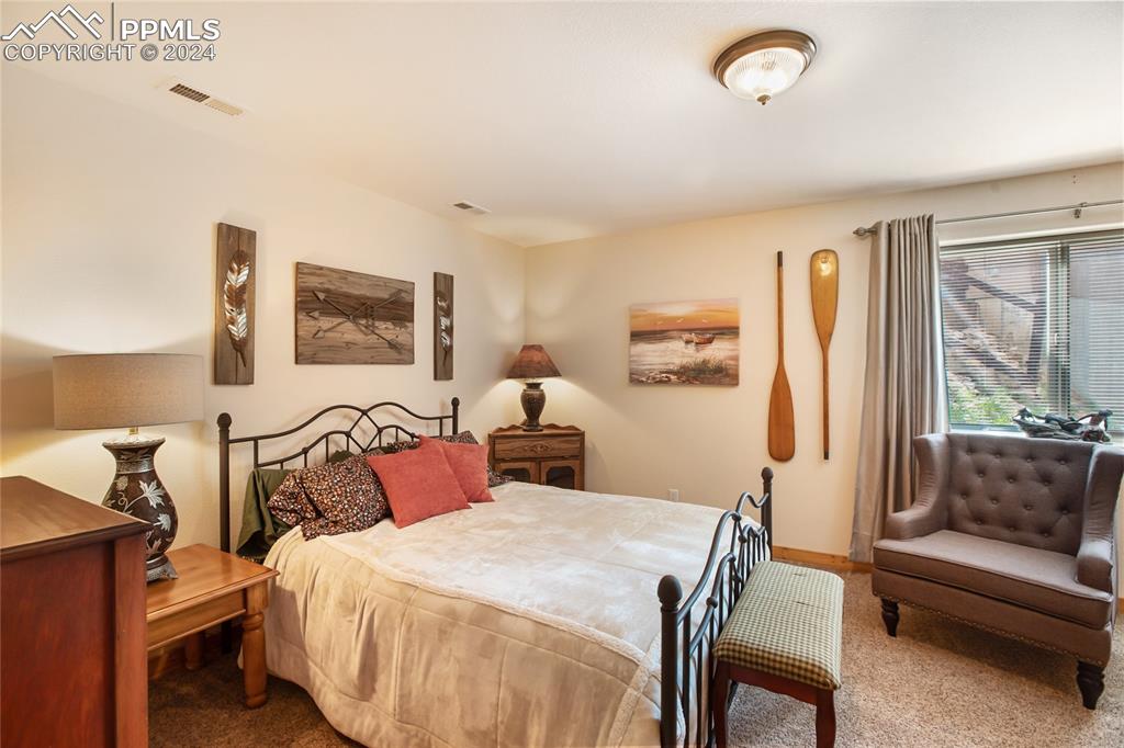 143 Wahsatch Road Florissant, CO 80816 - Photo 44 of 50 a bedroom with a bed and wooden floor