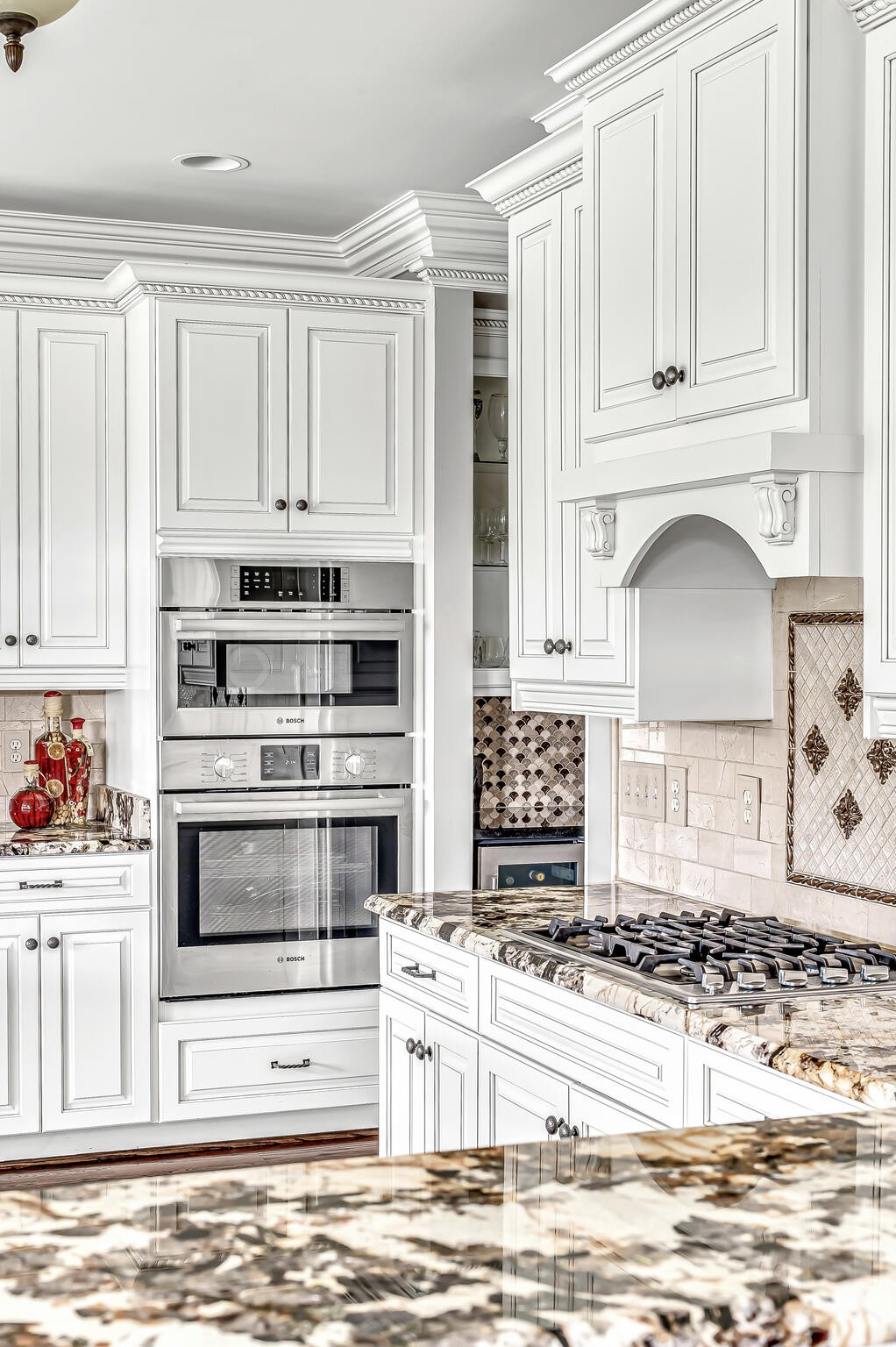 1101 Sunset Road Brentwood, TN 37027 - Photo 17 of 40 a kitchen with stainless steel appliances kitchen island granite countertop a stove a sink and white cabinets