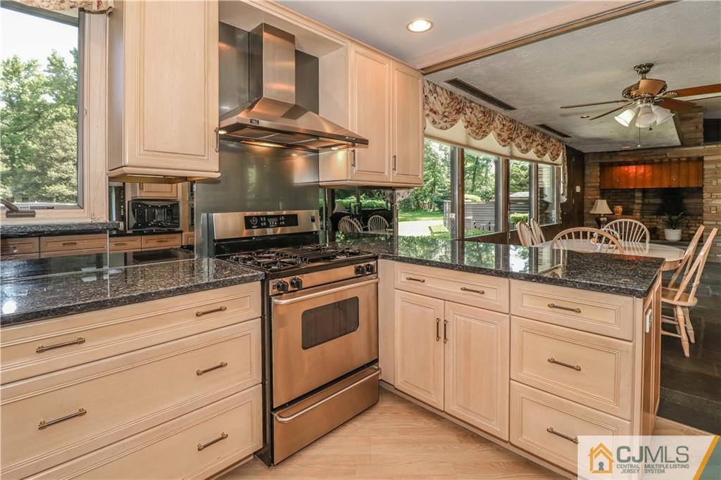 45 Sherwood Road Colonia, NJ 07067 - Photo 11 of 25 a kitchen with granite countertop stainless steel appliances a stove sink and cabinets