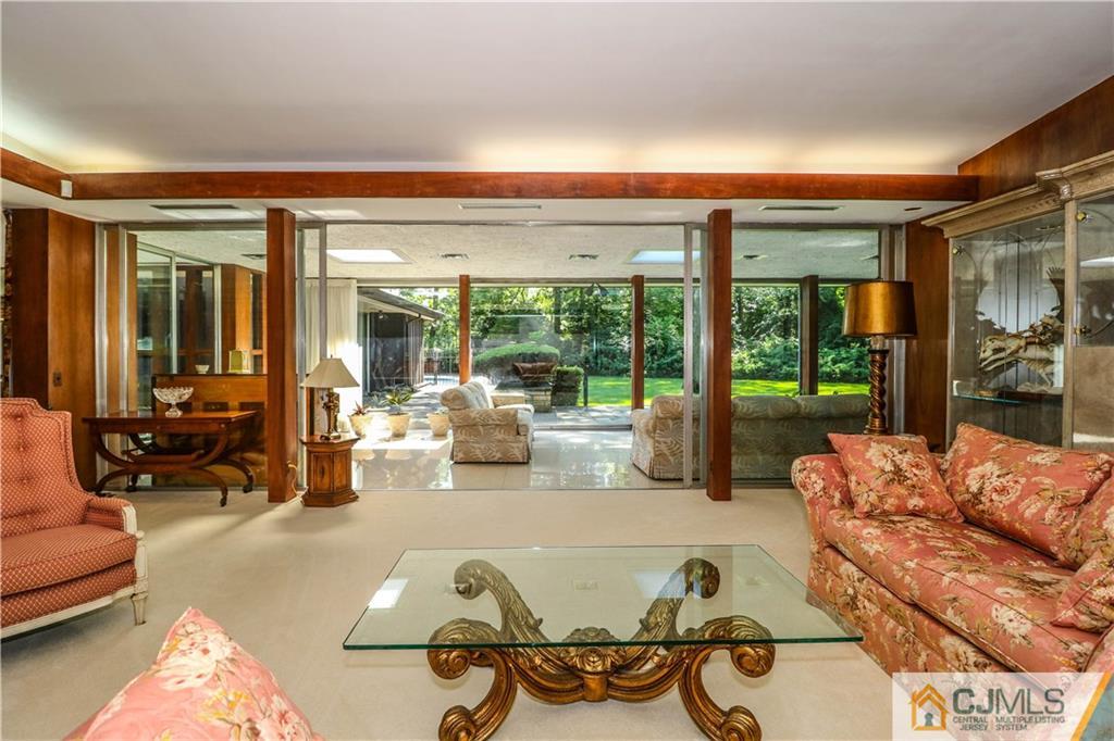 45 Sherwood Road Colonia, NJ 07067 - Photo 12 of 25 a living room filled with furniture and a large window