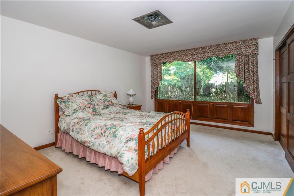 45 Sherwood Road Colonia, NJ 07067 - Photo 18 of 25 a bed sitting in a bedroom next to a window