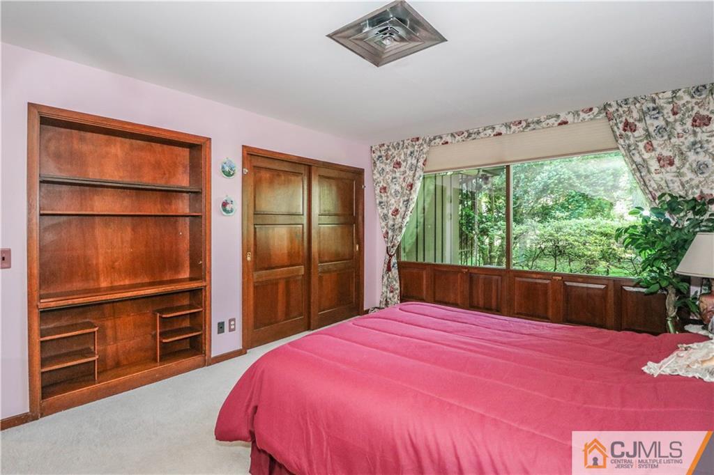 45 Sherwood Road Colonia, NJ 07067 - Photo 19 of 25 a bedroom with a bed and a dresser