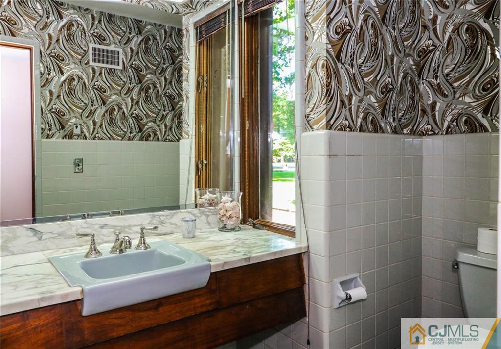 45 Sherwood Road Colonia, NJ 07067 - Photo 20 of 25 a bathroom with a sink and a mirror