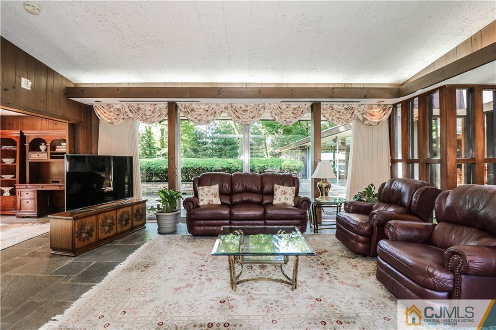 45 Sherwood Road Colonia, NJ 07067 - Photo 3 of 25 a living room with furniture and a flat screen tv
