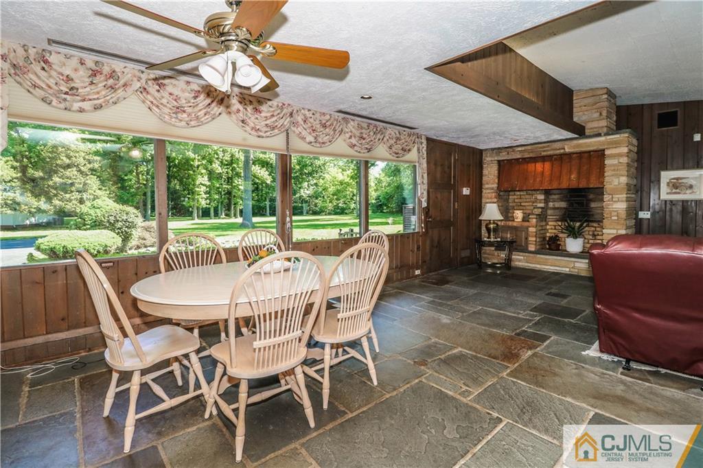 45 Sherwood Road Colonia, NJ 07067 - Photo 8 of 25 a dining room with furniture a rug and a large window