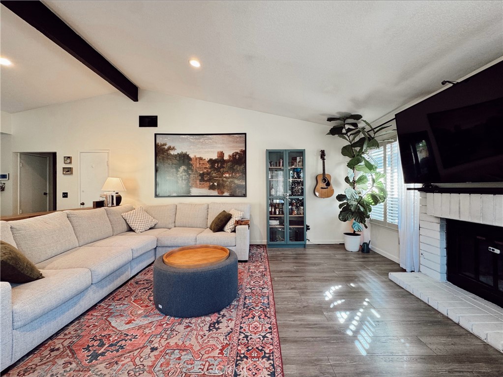 25941 Matel Road Valencia, CA 91355 - Photo 3 of 10 a living room with furniture a flat screen tv and a fireplace