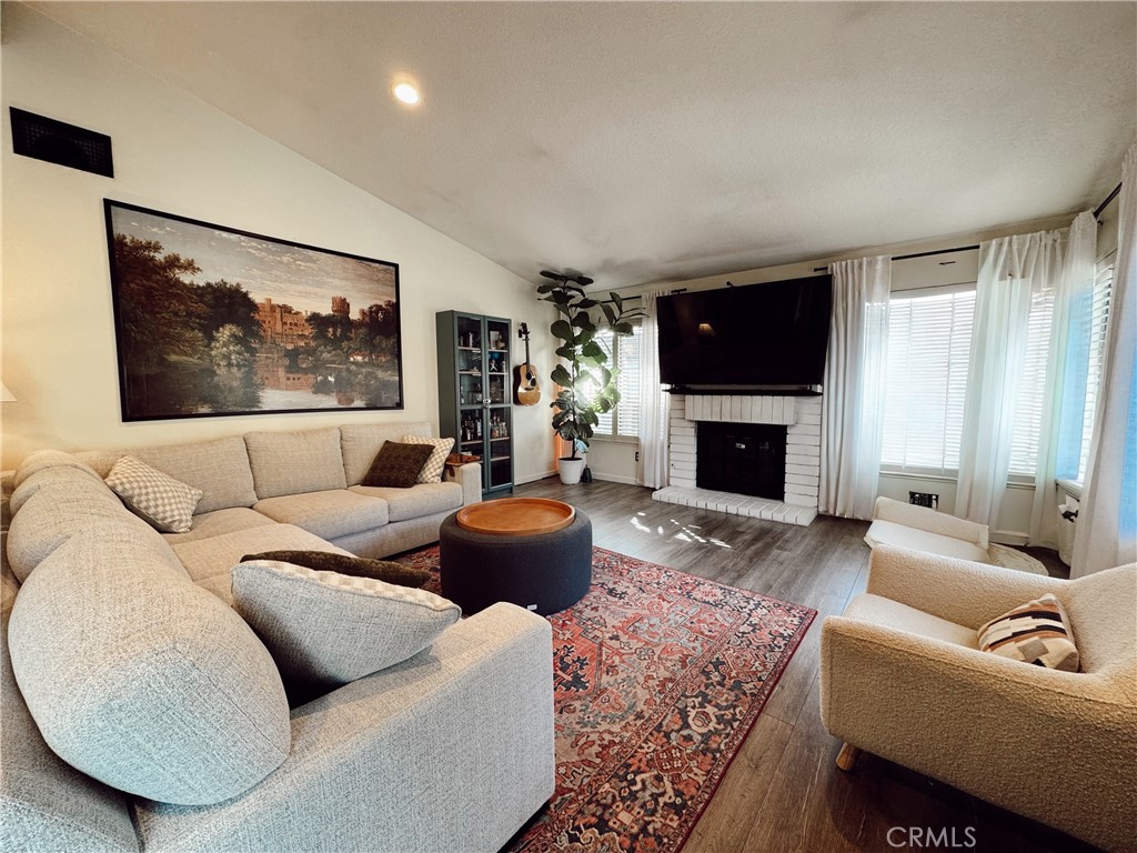 25941 Matel Road Valencia, CA 91355 - Photo 4 of 10 a living room with furniture a flat screen tv and a fireplace