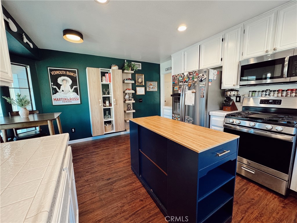 25941 Matel Road Valencia, CA 91355 - Photo 8 of 10 a kitchen with stainless steel appliances a stove refrigerator and a microwave