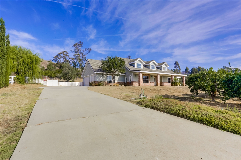 1021 Capra Way Fallbrook, CA 92028 - Photo 1 of 1 a front view of a house with a yard
