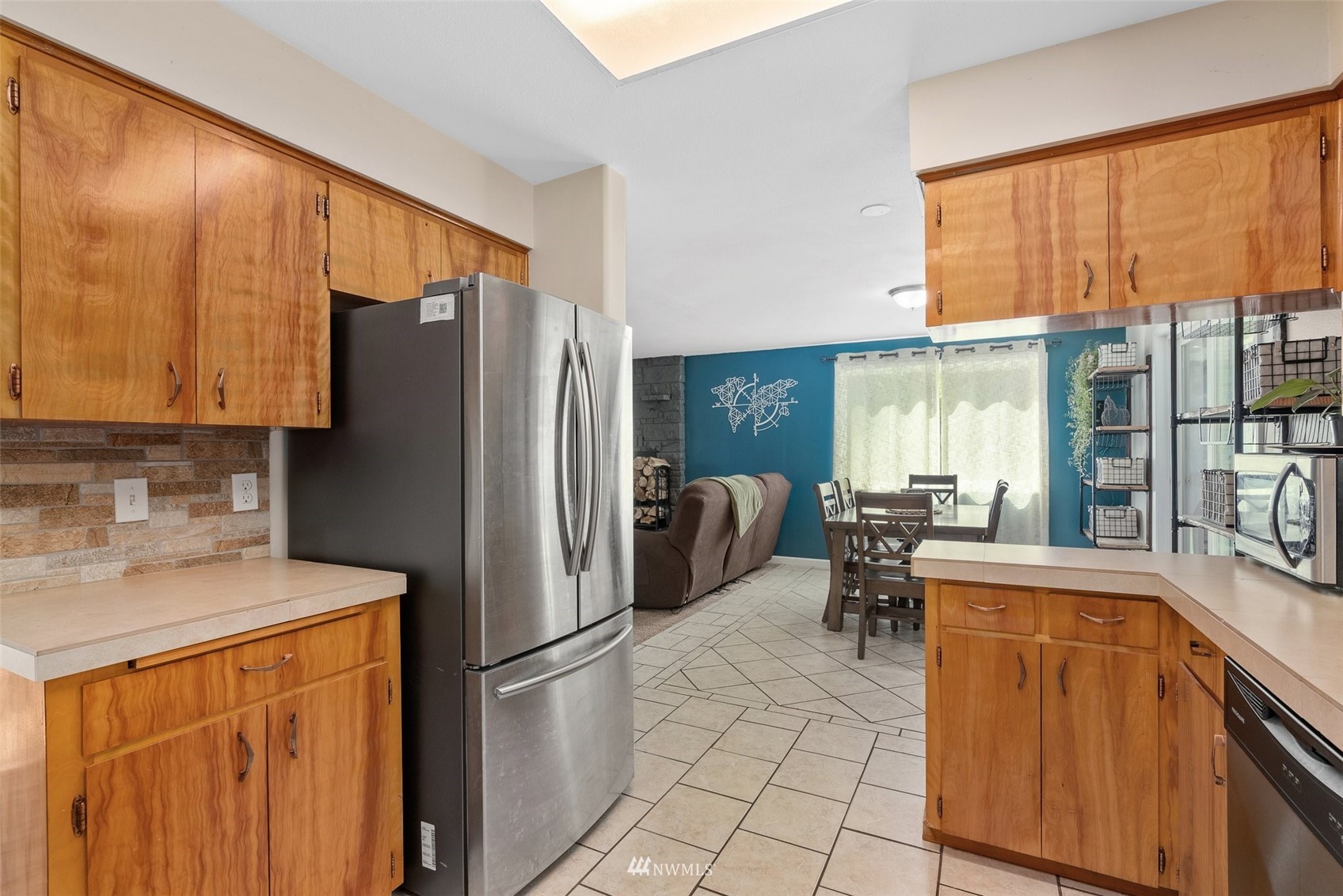 605 West Forest Napavine Road Chehalis, WA 98532 - Photo 13 of 34 a kitchen with stainless steel appliances a refrigerator a sink a stove cabinets and a dining table