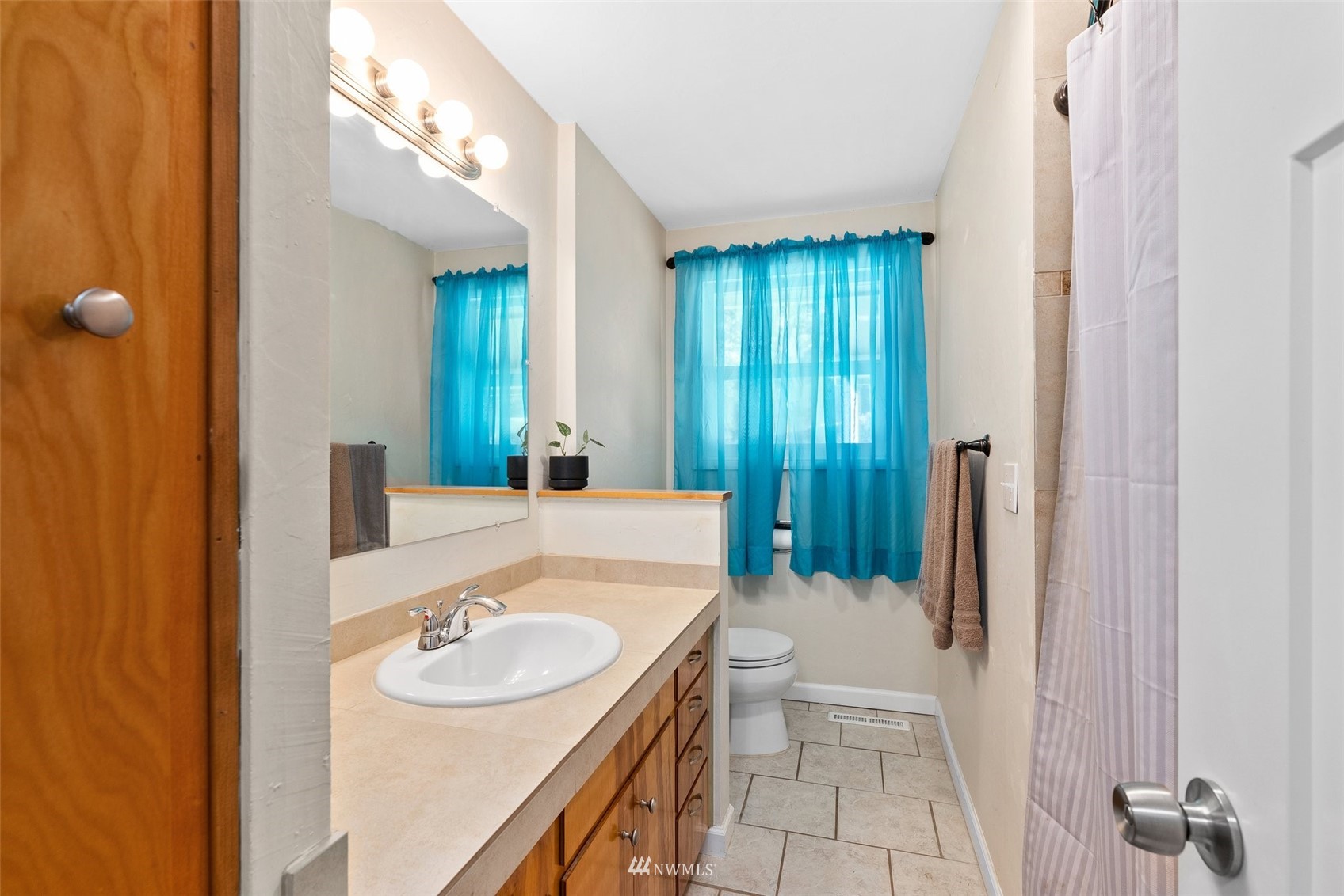 605 West Forest Napavine Road Chehalis, WA 98532 - Photo 14 of 34 a bathroom with a sink a toilet a mirror and shower