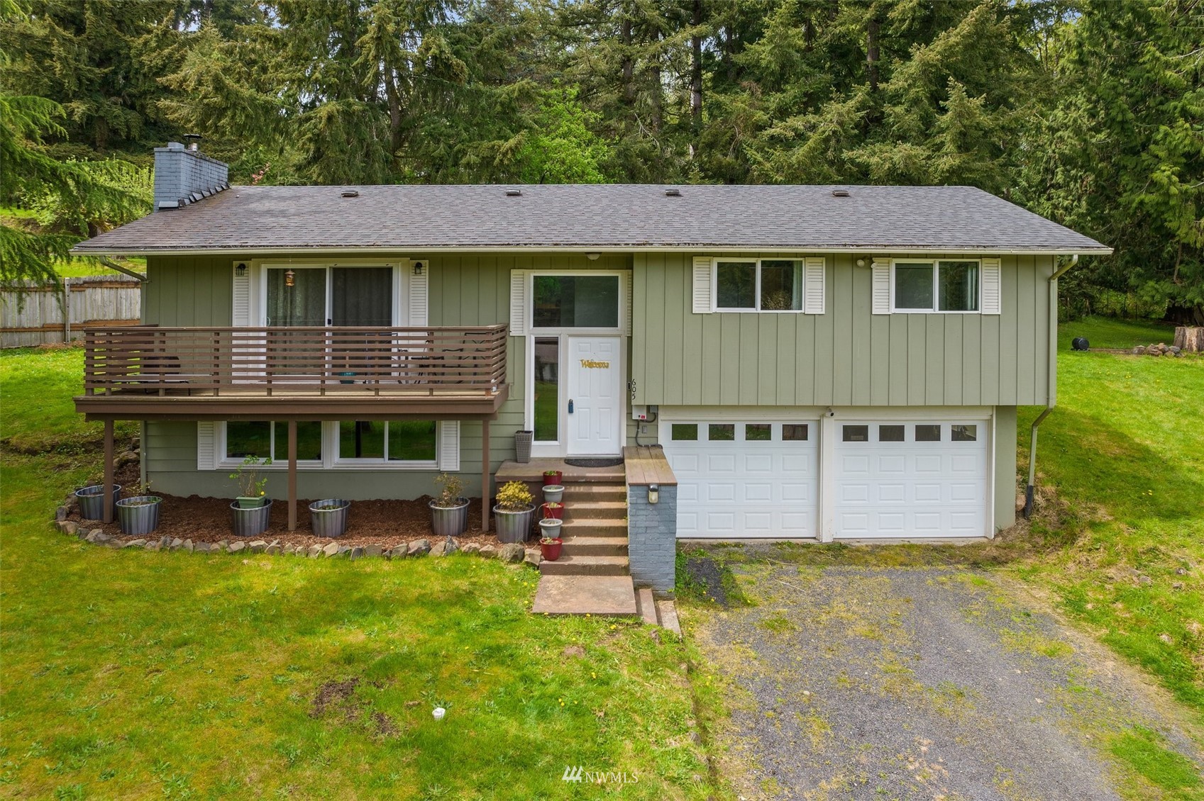 605 West Forest Napavine Road Chehalis, WA 98532 - Photo 2 of 34 a view of a white house with large windows and a table and chairs