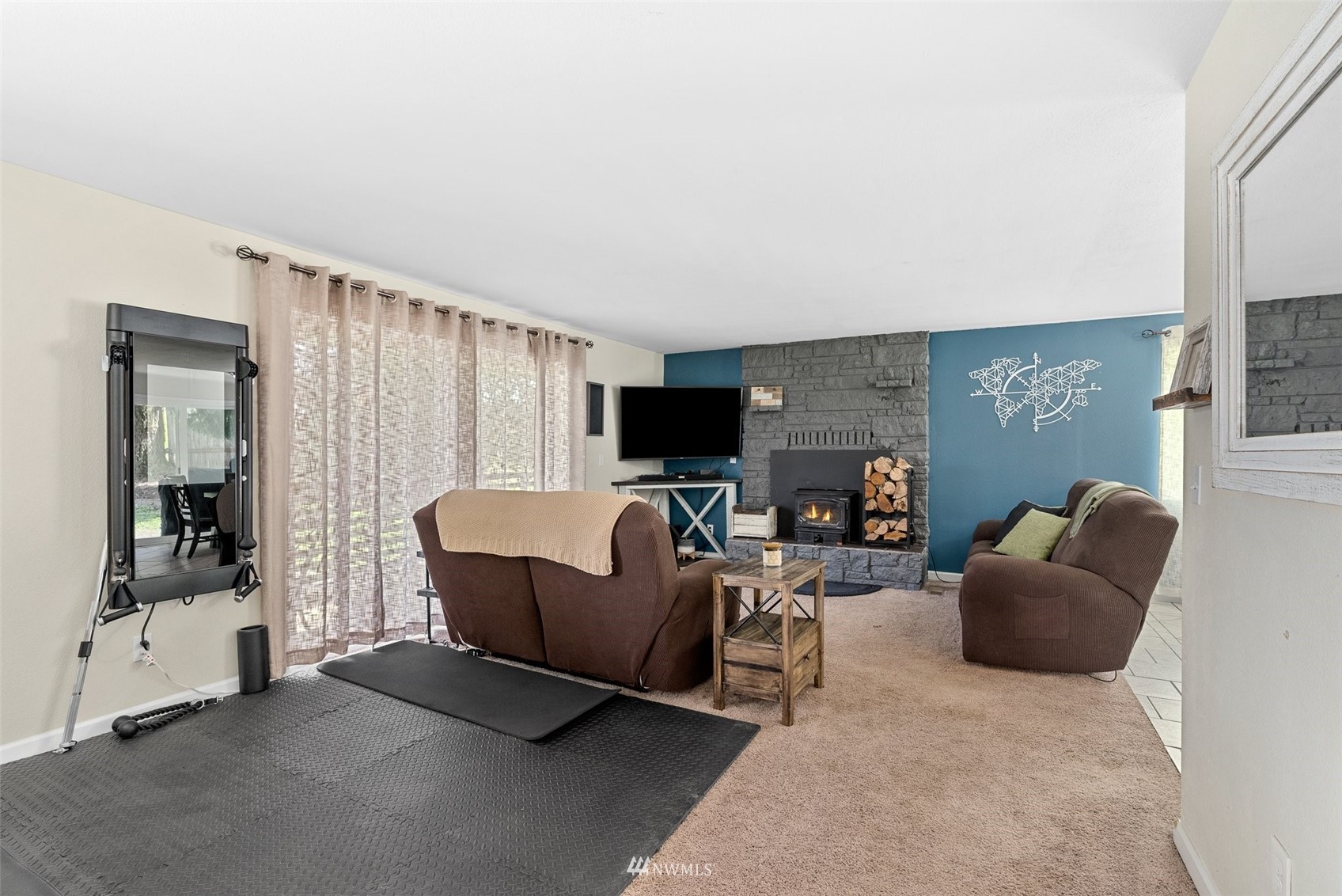 605 West Forest Napavine Road Chehalis, WA 98532 - Photo 8 of 34 a living room with furniture a flat screen tv and a fireplace