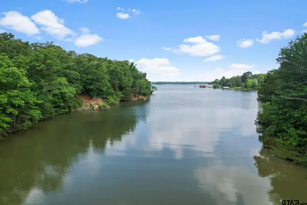a view of a lake in between two of trees
