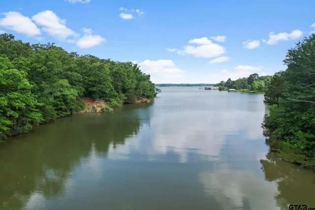 a view of a lake in between two of trees